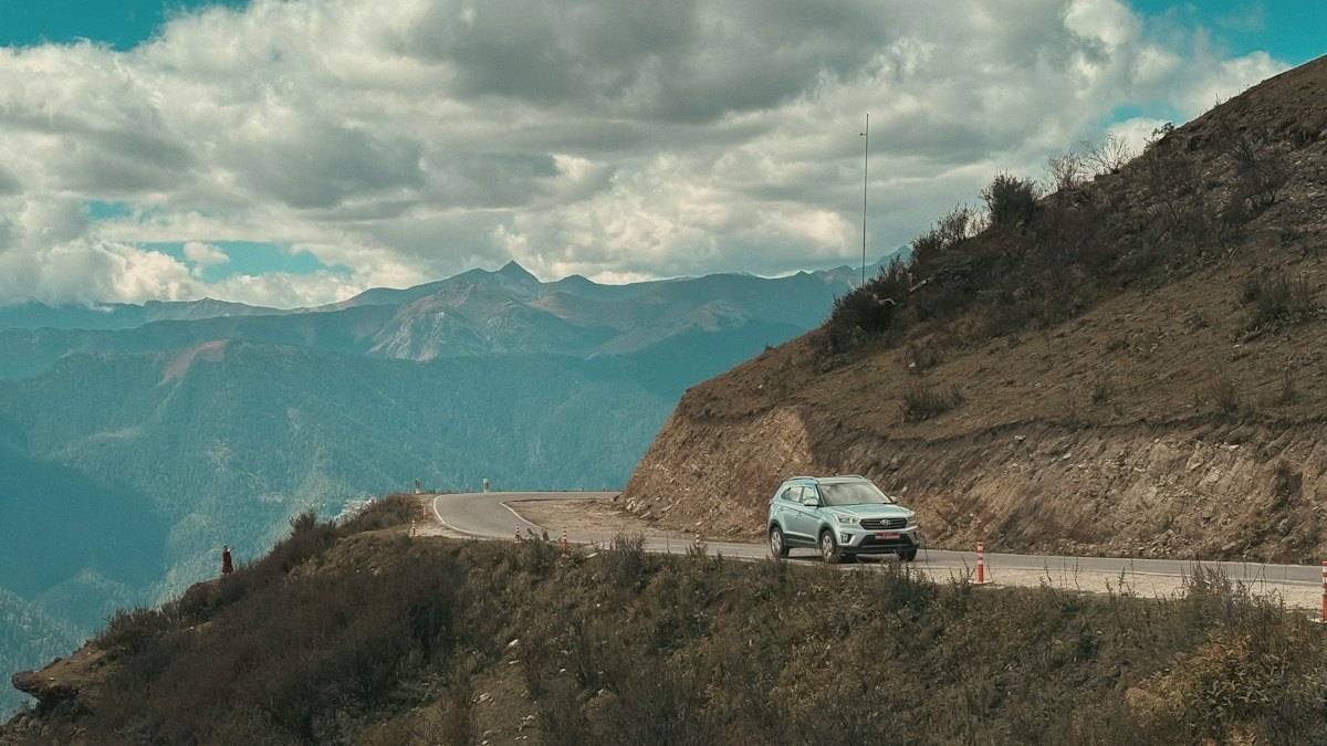 A white car on a winding mountain road