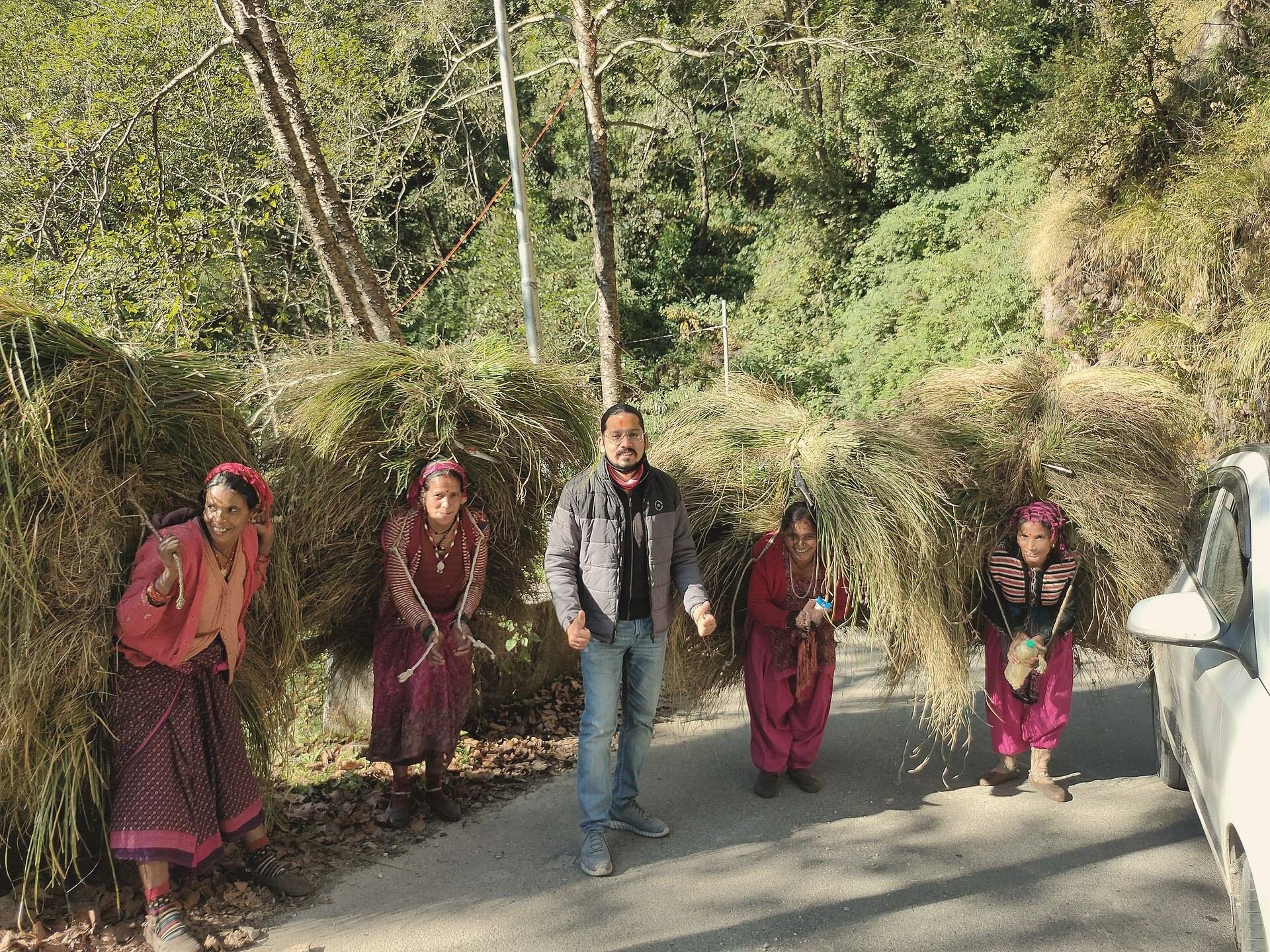 Village women carrying bundles of grass along the road to Triyuginarayan